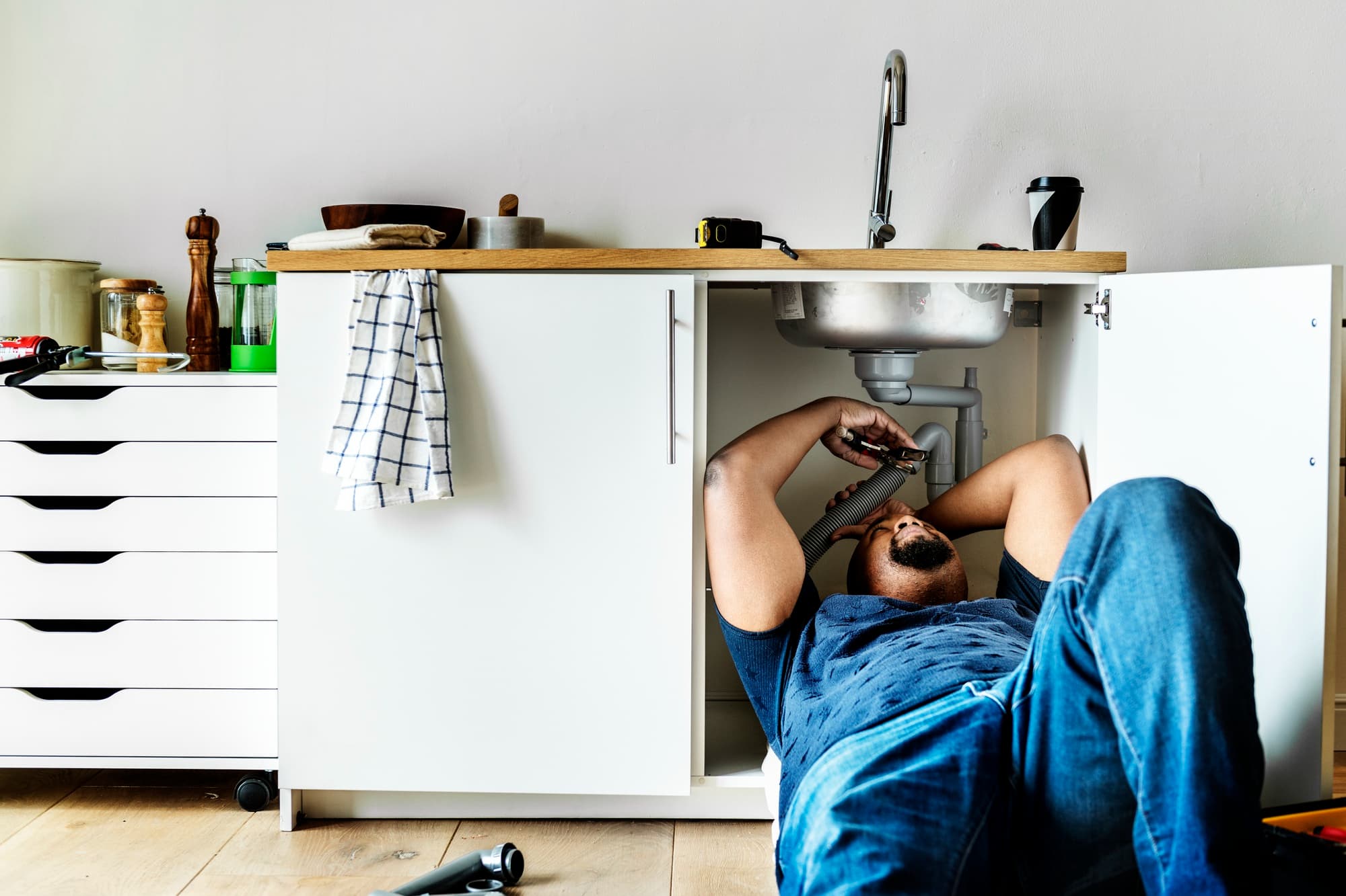 Plumber man fixing kitchen sink